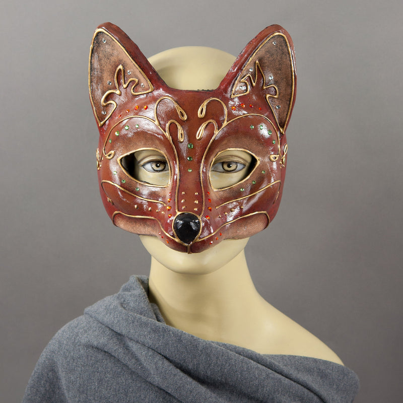 Fancy Red Fox Masquerade Mask. A lightweight comfortable mask inspired by the sly red fox, decorated with an elegant gold scroll motif and embellished with Swarovski Crystals and assorted gems.  Hand Made in the USA using traditional Venetian paper-mache techniques and lined with soft stretch velvet for comfort.