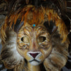 Stunning Lion Mask with a luxe crest of natural coque and assorted pheasant plumage. Embellished with Swarovski crystals, and assorted polished gem stones. Sure to turn heads at any costume, masquerade or Halloween party!  Hand-made in the USA using traditional Venetian paper-mache technique. Lined with hypoallergenic stretch velvet for comfort. Detail view.