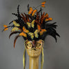 Beautiful Masquerade Mask, in shades of black and Metallic copper.Crested with black coque feathers and assorted dyed plumage. Orange and gold feather Monarch butterflies flutter on the crest. Embellished with Swarovski crystals, seashells and polished stones.  Hand made in the USA using traditional Venetian paper-mache technique. Lined with hypoallergenic stretch velvet for comfort. Detail.