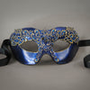 Simple, elegant eye mask in Metallic Sapphire Blue and Black with gold accents. Embellished with lacquered lace, glass gems, Swarovski crystals and polished stones.  Hand made in the USA using traditional Venetian paper-mache techniques. Lined in stretch velvet for comfort. Detail.