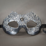Simple, elegant eye mask in Metallic Silver and Black. Embellished with lacquered lace, glass gems, Swarovski crystals and polished stones.  Hand made in the USA using traditional Venetian paper-mache techniques. Lined in stretch velvet for comfort. Detail.