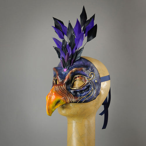 Skeksis inspired mask with diamond cut goose feathers and assorted gems. Side view.