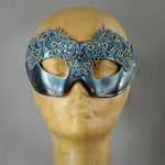 Simple, elegant eye mask in Metallic Turquoise Blue and Black. Embellished with lacquered lace, glass gems, Swarovski crystals and polished stones.  Hand made in the USA using traditional Venetian paper-mache techniques. Lined in stretch velvet for comfort.