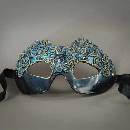 Simple, elegant eye mask in Metallic Turquoise Blue and Black. Embellished with lacquered lace, glass gems, Swarovski crystals and polished stones.  Hand made in the USA using traditional Venetian paper-mache techniques. Lined in stretch velvet for comfort. Detail.