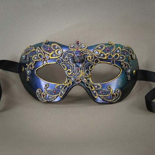 Simple, elegant eye mask in Iridescent Green, Blue and Black. Embellished with lacquered lace, glass gems, Swarovski crystals and polished stones.  Hand made in the USA using traditional Venetian paper-mache techniques. Lined in stretch velvet for comfort. Detail.