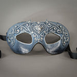 Simple, elegant eye mask frosted in white over black. Embellished with lacquered lace, glass gems, Swarovski crystals and polished stones.  Hand made in the USA using traditional Venetian paper-mache techniques. Lined in stretch velvet for comfort. Detail.